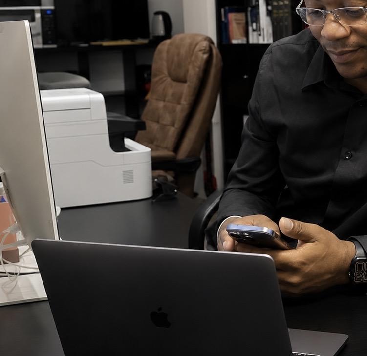 Professional working on digital marketing with laptop and phone